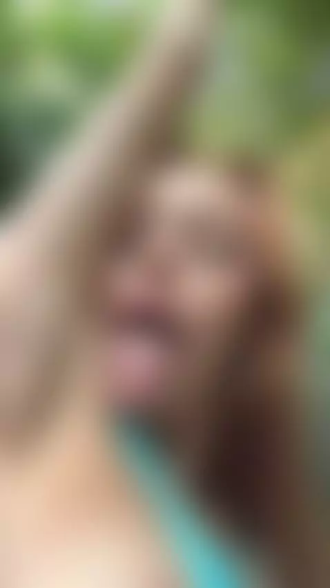 18+ Sexy redhead's perky tits peek through blue bikini, tong... by adelka2003