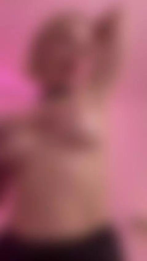 Blonde babe teasing her tits for the camera in pink lighting by alexagreyforyou