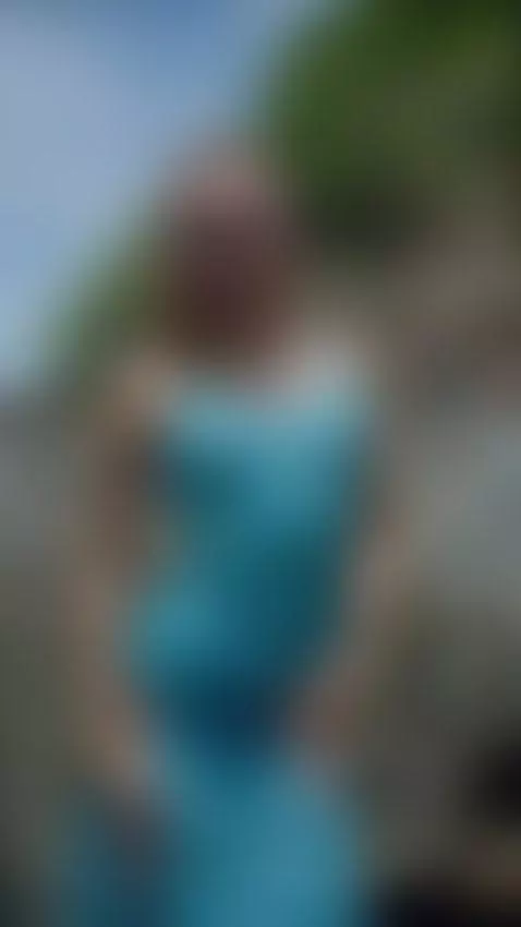 Nerdy girl in blue dress teases with thigh slit on rocks by ellynextdoor
