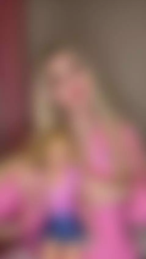 Sweet blonde beauty in pink teasing with her doll by stellats