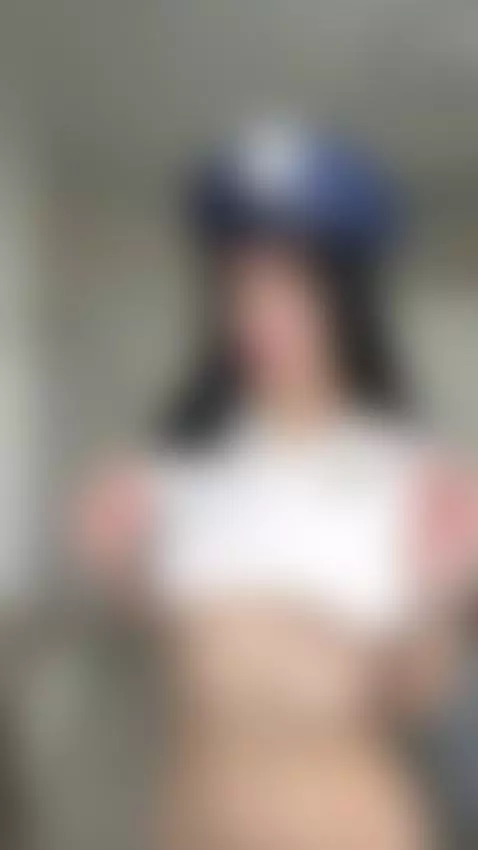 This freckled black-haired girl in a police hat lifts her sh... by lollahoney