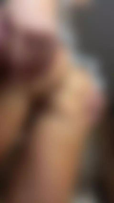 Close-up of her hand with long nude nails gripping the soft ... by lanamoor