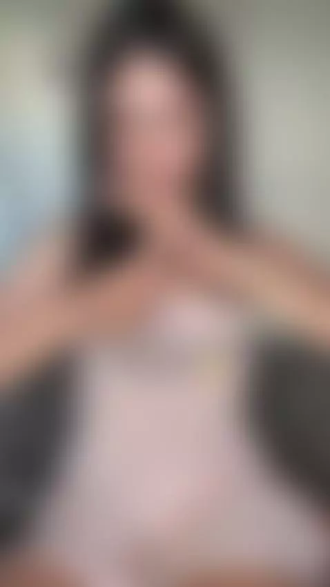 She frames her face with fingers while tilting her hips forw... by sofits