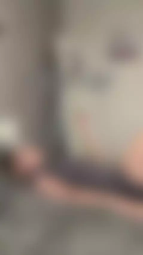 Tattooed arm rests above her head as she lies back by sofits
