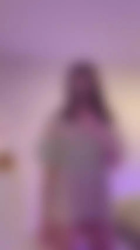 Tattooed hip peeking out under a loose tee as she snaps the ... by sofits