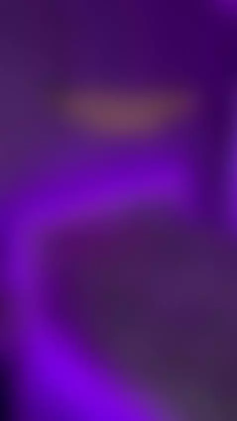 Empty bed glowing purple under plush blanket and penguin 🤤 by sofits