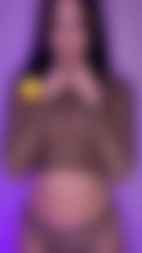 She teases her neck with both hands under purple light 🫦 by sofits